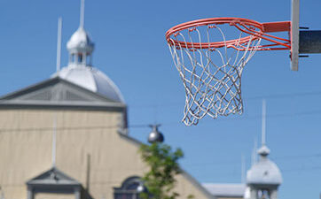 Image of a basketball net with the Aberdeen Pavilion in the background