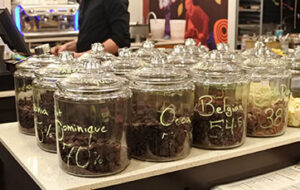 different jars filled with different types of chocolate pellets at Cacao 70