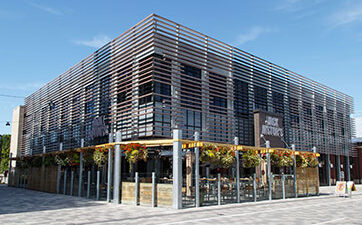 Image of the front of Jack Astor's restaurant with the patio at TD Place