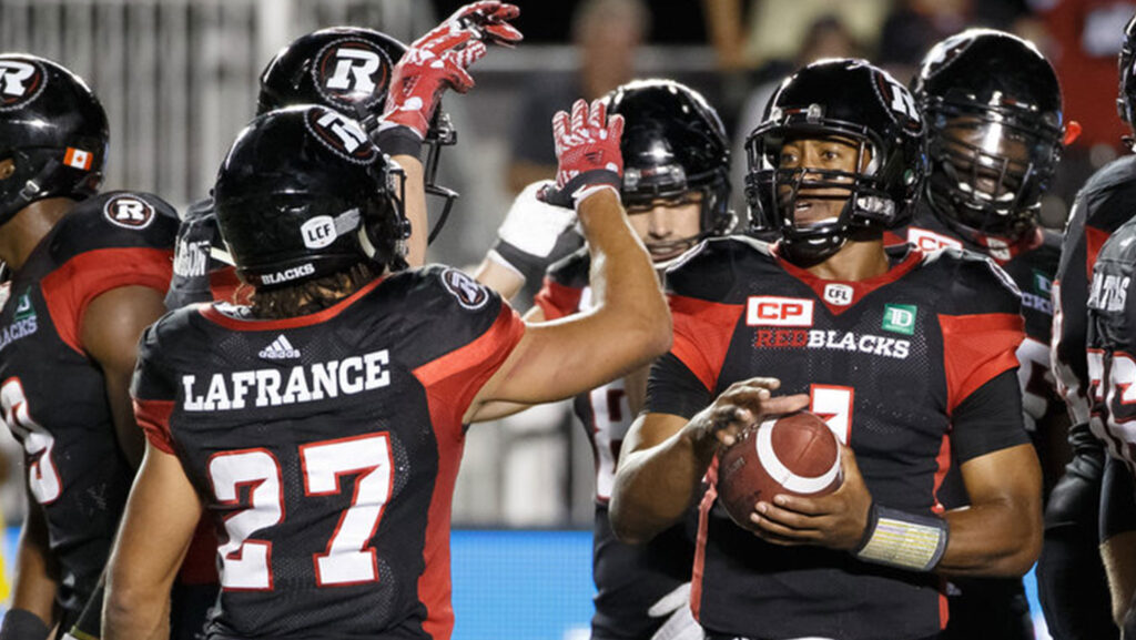 Image of Henry Burris during a game celebrating with other players