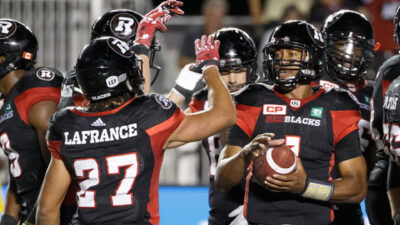 Image of Henry Burris during a game celebrating with other players
