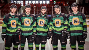 Image of five 67's players wearing the green St. Patty's Day jerseys
