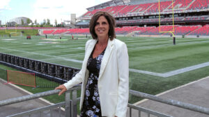 Image of Janice Barresi standing next to the football field