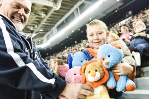 Image of 67's fans with teddy bears to toss on the ice