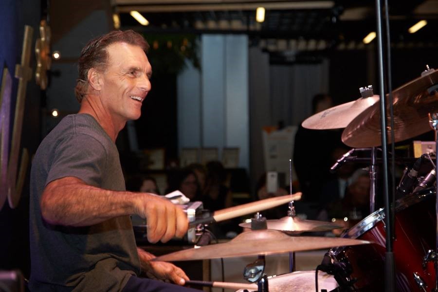 Image of former CFL quarterback Doug Flutie playing drums