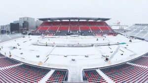 Image of the stadium prep before the outdoor game on a snowy day