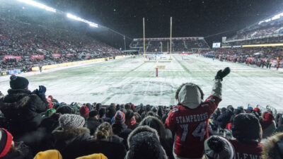 Full stadium of fans cheer for the 105th Grey Cup at TD Place on a snowy night