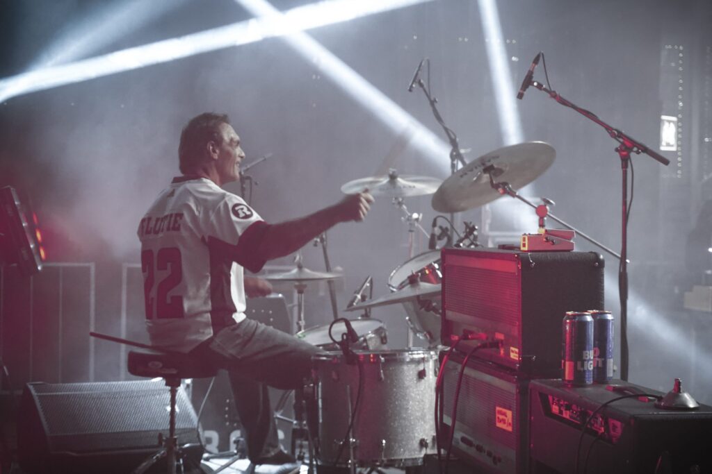 Image of former CFL quarterback Doug Flutie playing drums