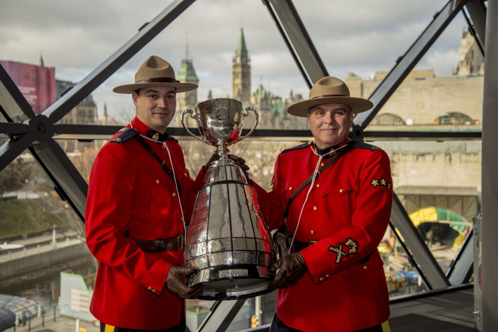 Image of 2 Canadian Mounties holding the Grey Cup
