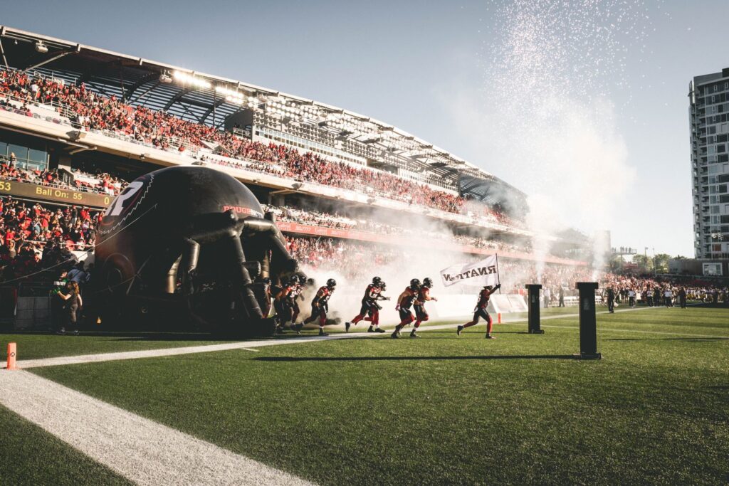Image of REDBLACKS players exiting the tunnel on the field at the start of a game