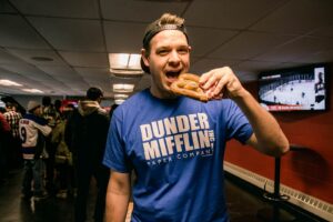 Image of Tyler eating a pretzel at Dinder Mifflin night at the 67's game