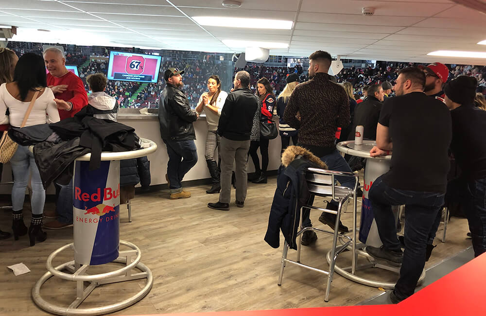 people hanging out in the VIP Barbershop area at a 67's game