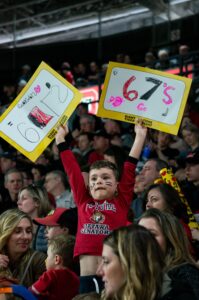 Image of a young 67's fan cheering in the crowd