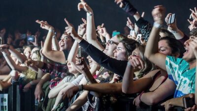 Image of fans cheering from the front row