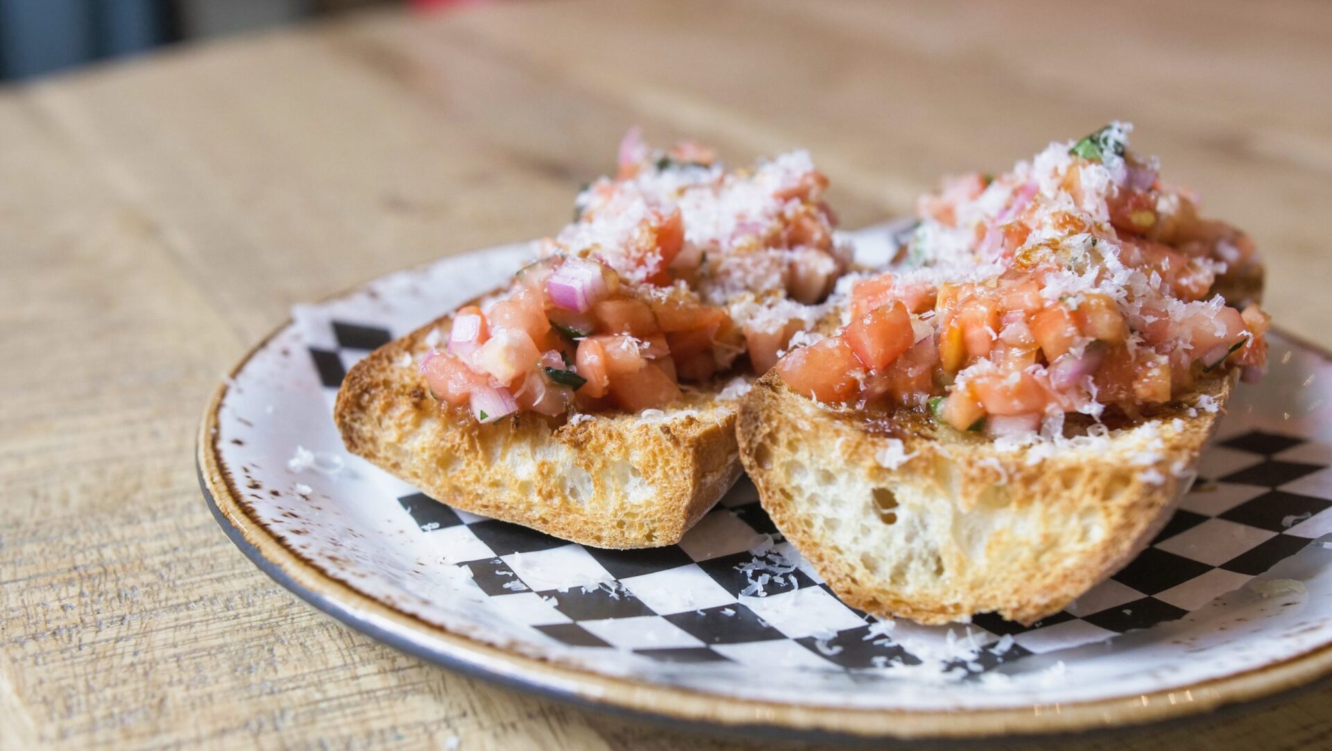 A plate with 2 pieces of bruschetta