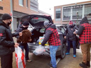 Image of 67's players and staff working at the holiday toy drive at TD Place