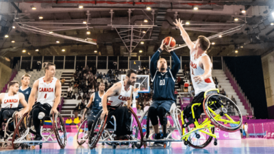 Image of basketball players in wheelchairs playing on the court