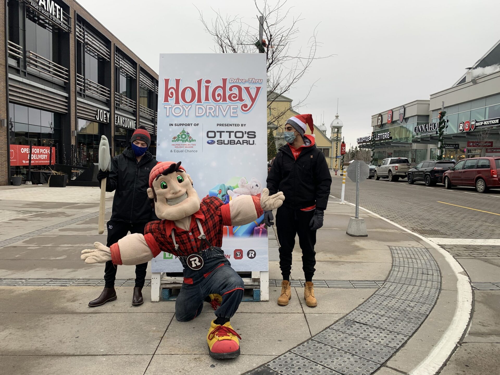 Big Joe and 2 67's players promoting the Holiday Toy Drive.