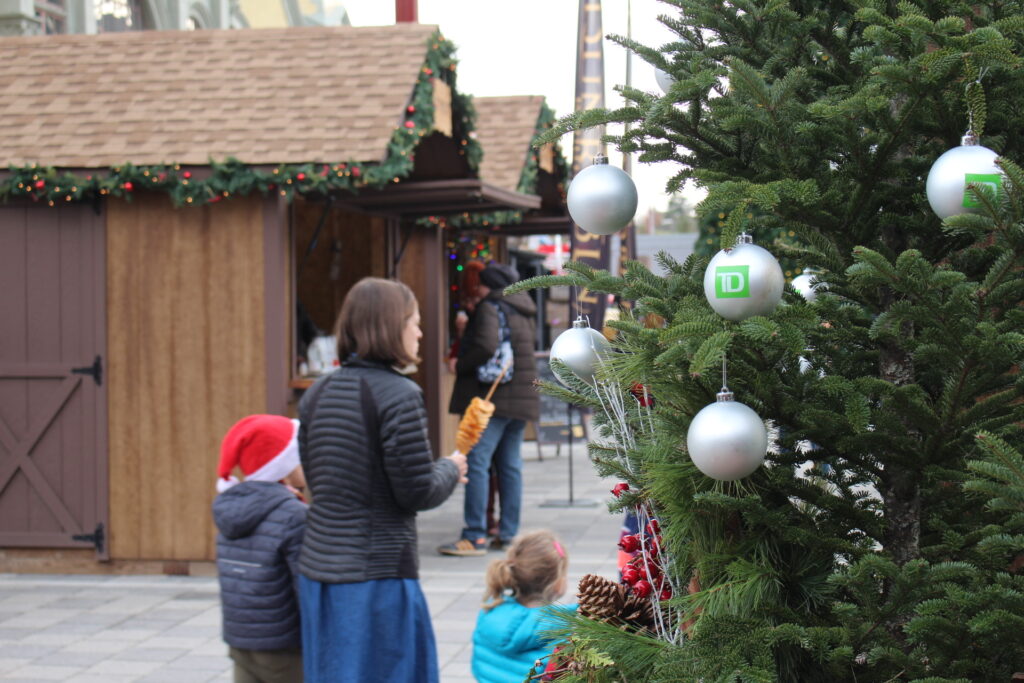 family at the Ottawa Christmas Market in front of the Christmas tree