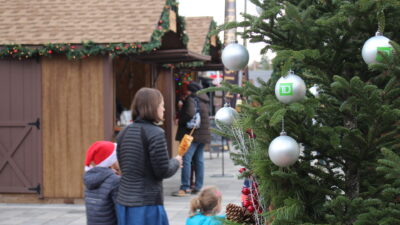 family at the Ottawa Christmas Market in front of the Christmas tree